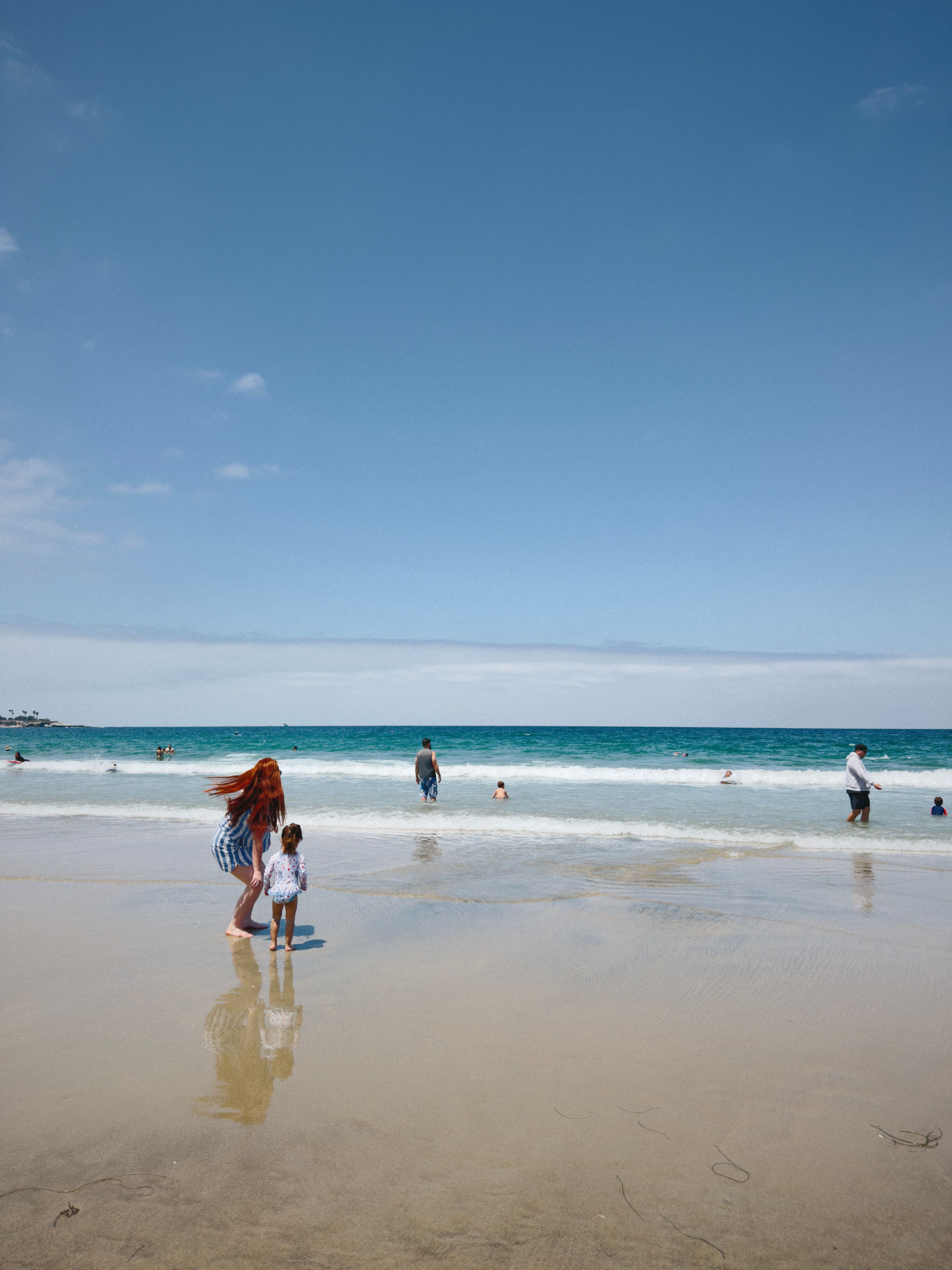 A picture of a beach, with people